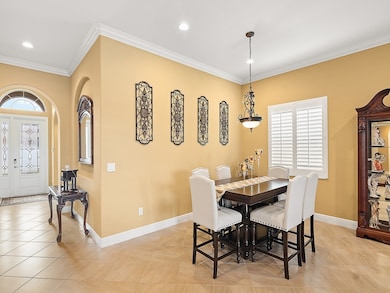 Dining room with ornamental molding, light tile patterned flooring, and recessed lighting