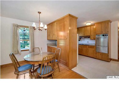 Eat-in kitchen opens to the screened-in patio.