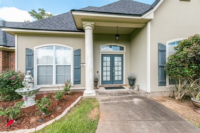 View of exterior entry with french doors, roof with shingles, and stucco siding