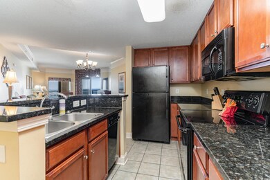 Kitchen featuring black appliances, a notable chan