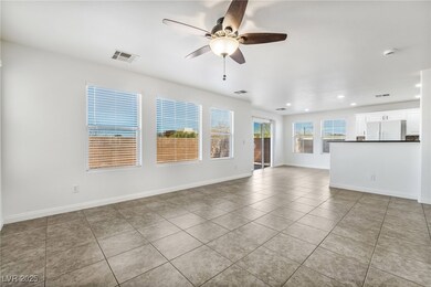 Unfurnished living room featuring light tile patte
