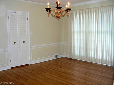 Formal Dining with Wainscoating & Glistening Hardw