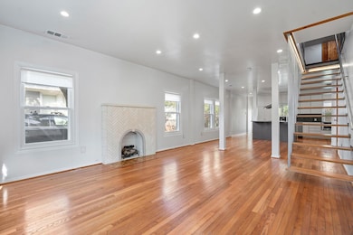 Unfurnished living room with visible vents, basebo