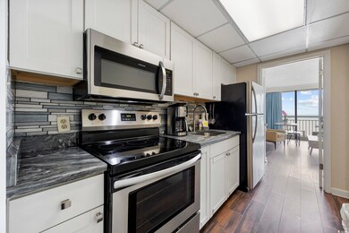 Kitchen with stainless steel appliances, a sink, t
