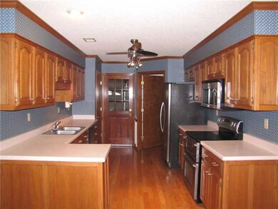 Accented with hardwood floor, ceiling fan, wood tr