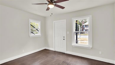 Entryway with dark wood finished floors and ceiling fan