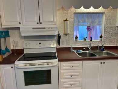 Kitchen featuring sink, white electric range oven,