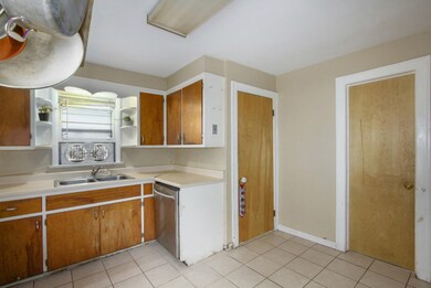 Kitchen with bathroom door to the right