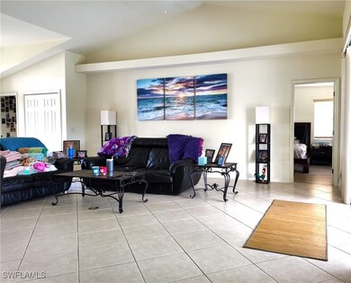 Tiled living room with vaulted ceiling