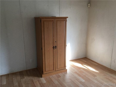 Unfurnished bedroom with light wood-style flooring