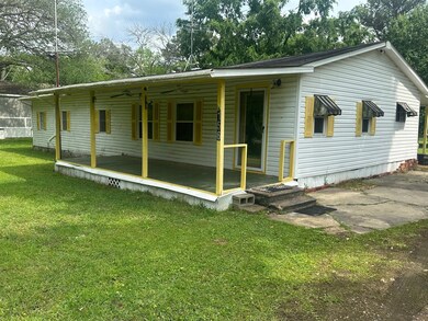 Rear view of property featuring a yard