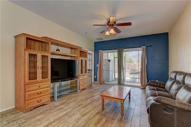 Living area with light wood-type flooring, a ceili