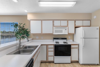 Kitchen featuring light wood-type flooring, white 