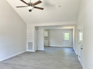 Plenty of space for sectional, lazyboy chairs and any furniture arrangements. Eatin kitchen in the back. Garage door and door to rrimary bedroom on the right.