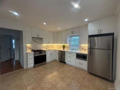 Kitchen with white cabinets, NEW stainless steel appliances, granite counters, and recessed lighting.