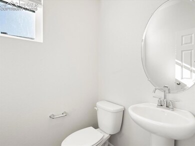 Half bathroom with toilet and a sink