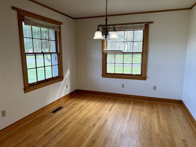 Beautiful hardwood floors in the formal dining room with new light fixture.