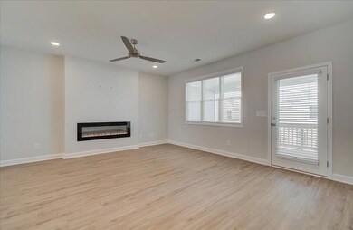 This space has endless possibilities. Large family room with the modern electric fireplace.