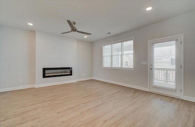 This space has endless possibilities. Large family room with the modern electric fireplace.