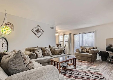 Living area with wood finished floors and ceiling