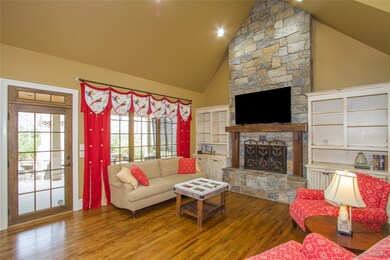 Family Room with stone fireplace, built-in bookshe