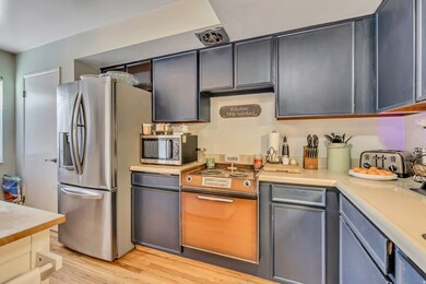 Kitchen featuring stainless steel appliances, light countertops, and light wood-style floors