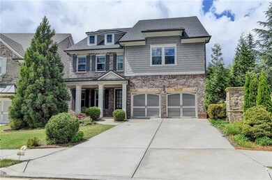 Craftsman house with brick siding, an attached gar