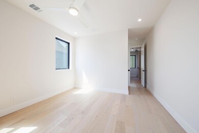Empty room with light wood-style flooring, visibl