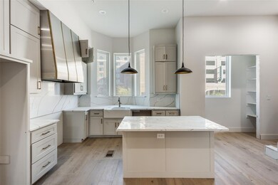 Kitchen featuring full height quartz backsplash, c