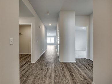 Entry from front door towards living areas, secondary bedrooms to the right and left