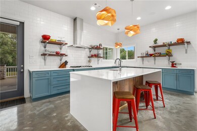 Custom walnut island and quartz countertops.