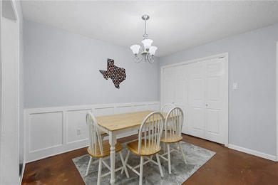 Dining room featuring a chandelier, concrete floor