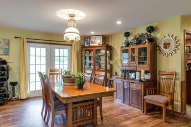 Large dining room w/ doors leading out to the back porch 