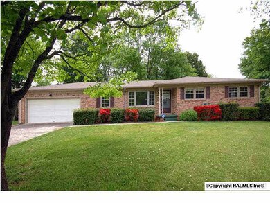 Situated on large corner lot, features two-car garage.