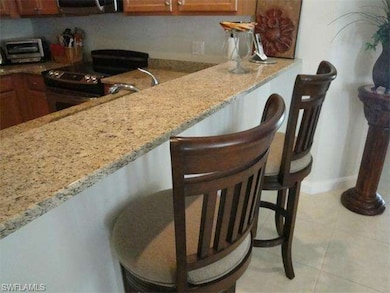 Kitchen features a large breakfast bar.