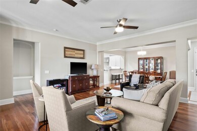Living room featuring ornamental molding, dark har