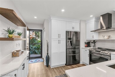 Kitchen with wall chimney range hood, open shelves