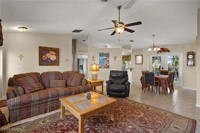 Living room featuring ceiling fan with notable cha
