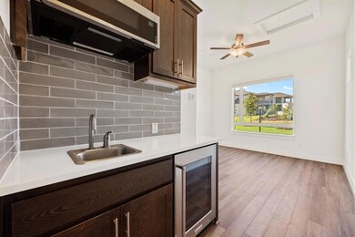 Kitchen featuring wine cooler, a sink, stainless 