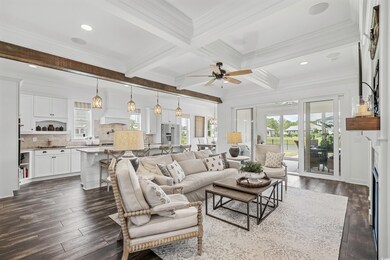 Living room featuring beam ceiling, dark wood-type