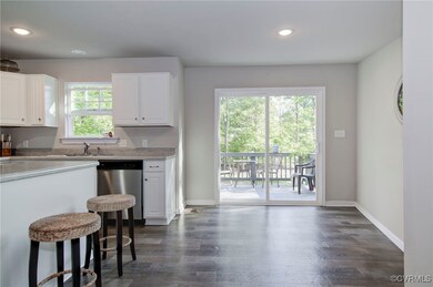 Kitchen featuring dishwasher, white cabinets, and