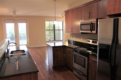 Lovely high end kitchen has tall cabinets, granite