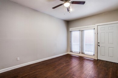 Spare room featuring dark wood finished floors, ba