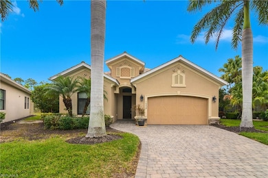 Mediterranean / spanish home featuring decorative driveway, stucco siding, a garage, and a front lawn