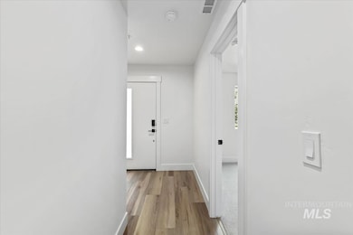 Corridor featuring light wood-style flooring and recessed lighting