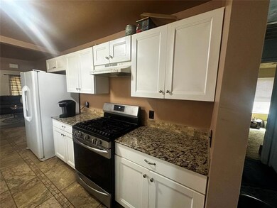 Kitchen with dark stone countertops, freestanding 