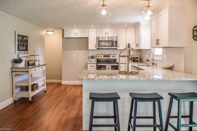 The kitchen has stainless steel appliances and a b