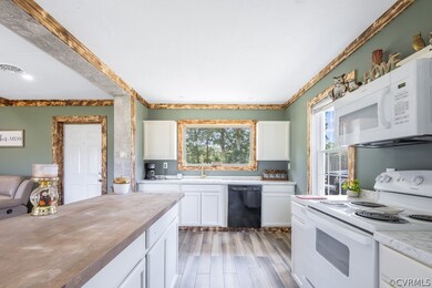 Kitchen featuring butcher block countertops, white