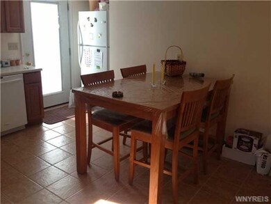 Exterior Front large eat in kitchen with ceramic tile floor and a door that leads to a wood deck and fully fenced yard on side and rear