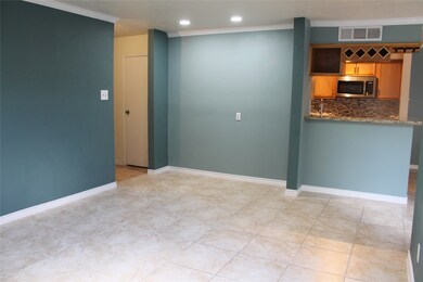 Living room with recessed lights and tile floor.